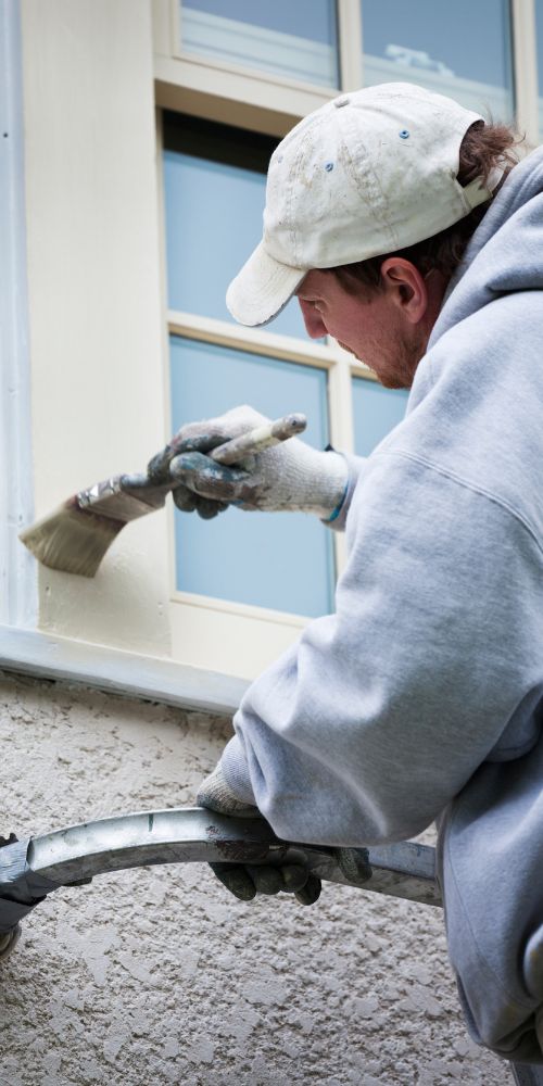 Commercial Painting Services Provider Applying Paint On Window Frame
